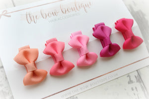 My first pink & peach mini pinch bows I clip or bobbles