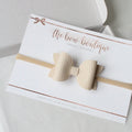 Nude leather look bows