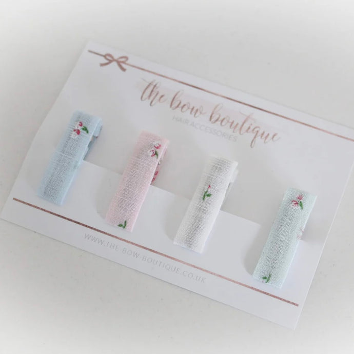 Set of 4 mini floral linen clips.