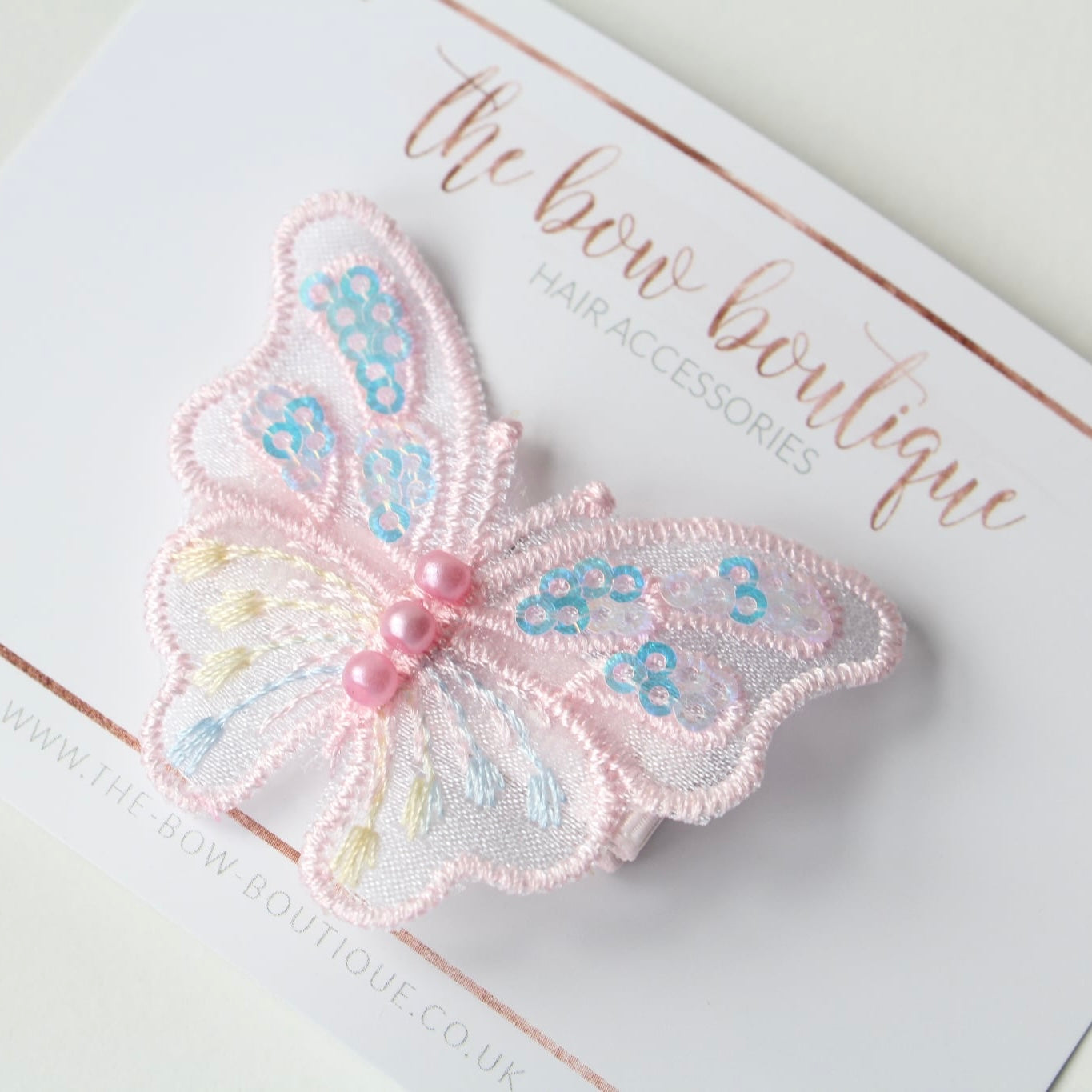 Light pink iridescent butterfly clip