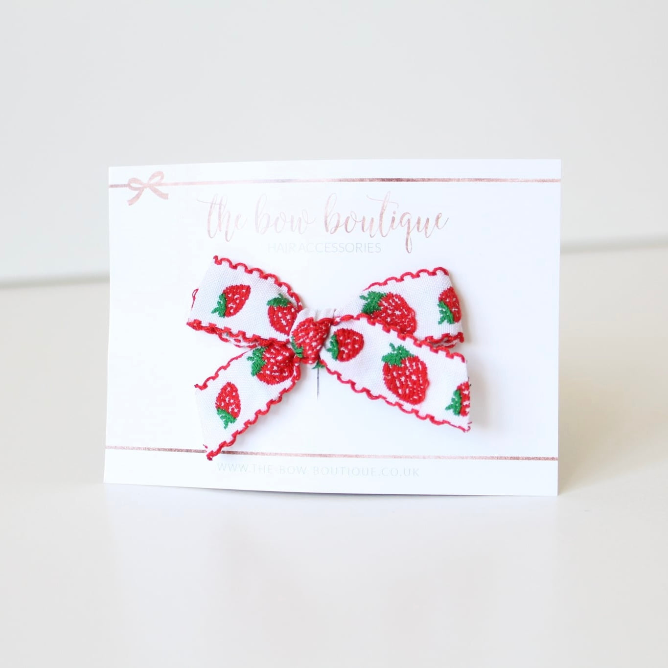 Hand tied red strawberry bows | Clip or headband