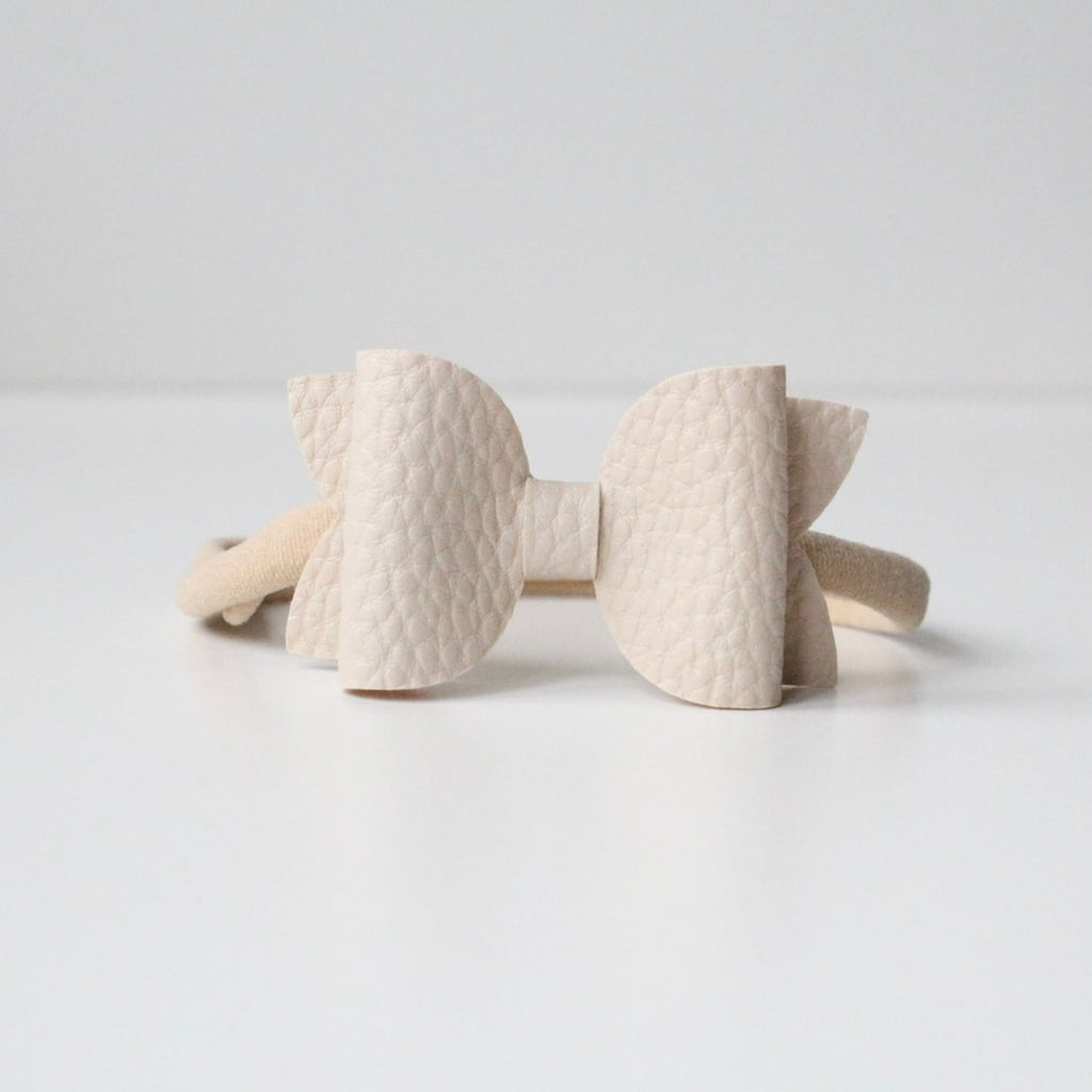 Nude leather look bows