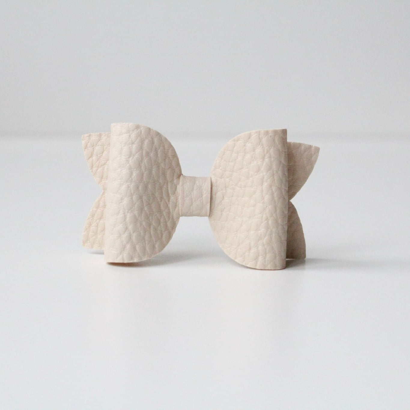 Nude leather look bows