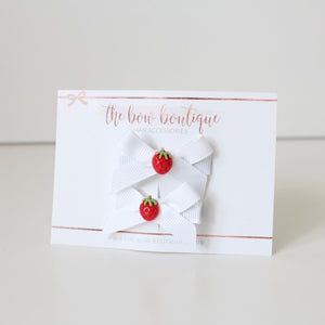 White hand tied strawberry ribbon bow clip