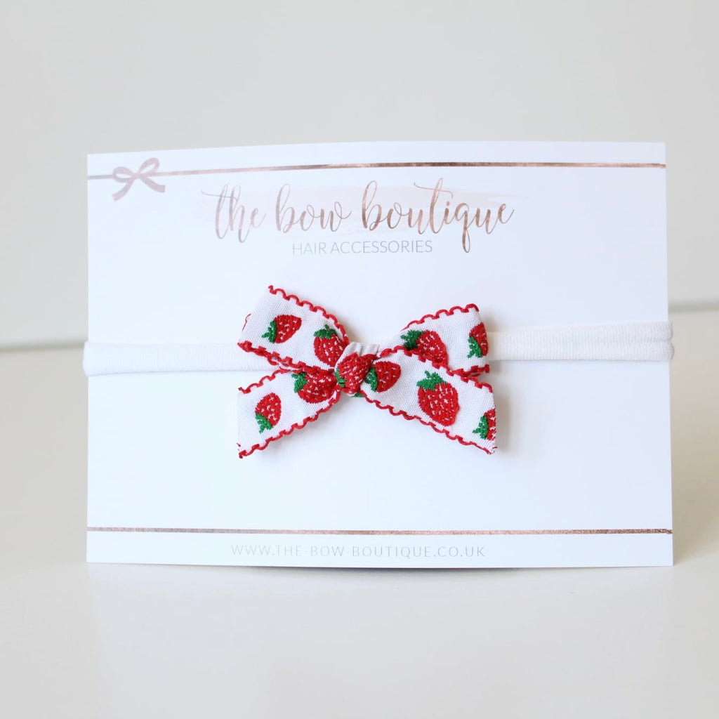 Hand tied red strawberry bows | Clip or headband