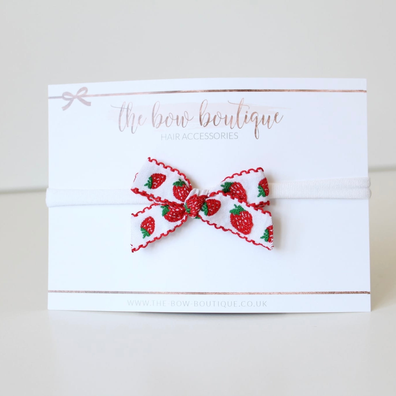 Hand tied red strawberry bows | Clip or headband