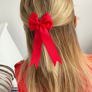 Large red tail pinch ribbon bows