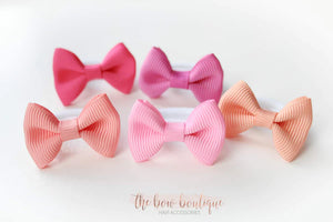 My first pinks mini pinch bows I clip or bobbles